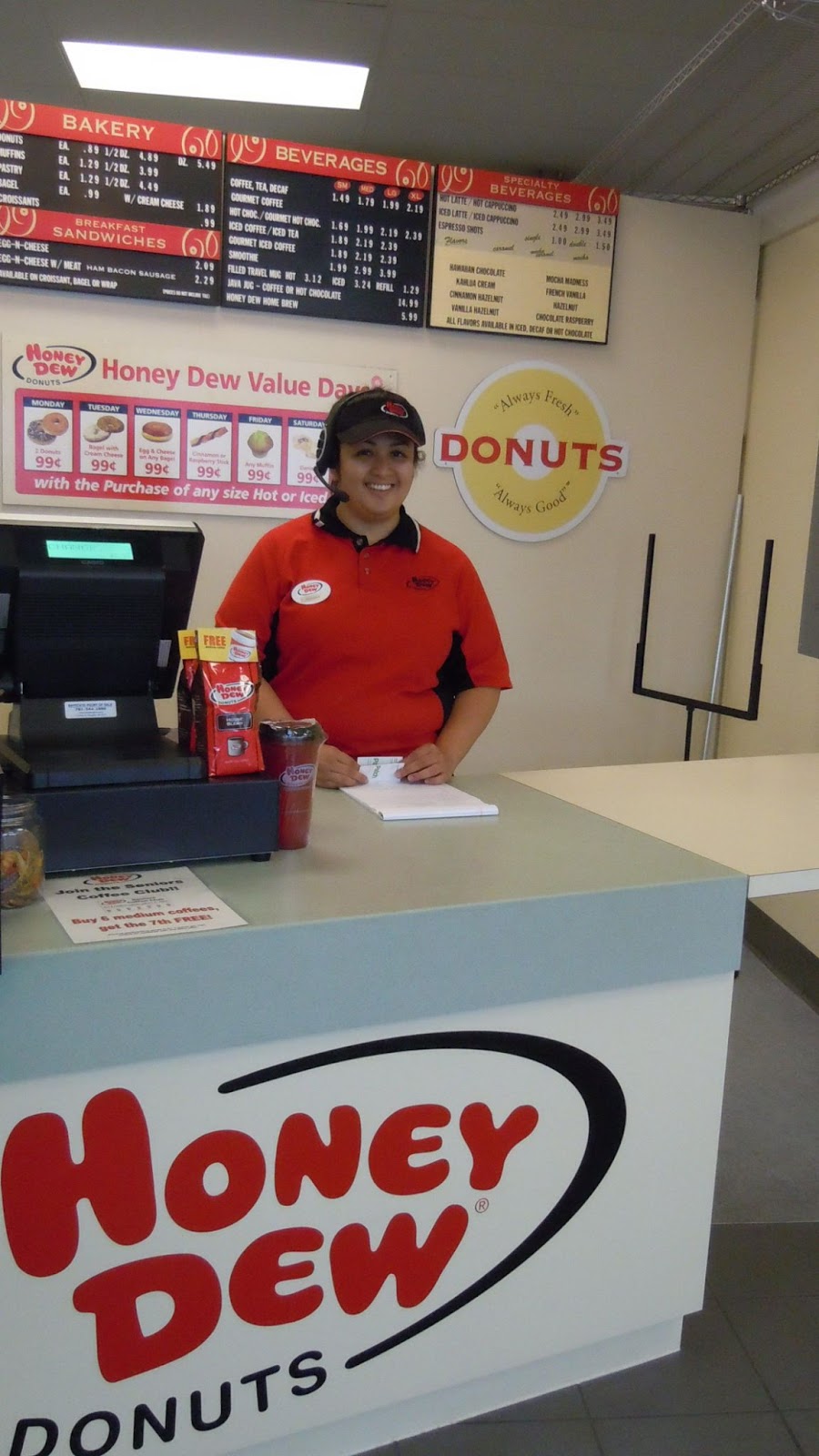 <u>Query</u>: A donut shop employee in a red shirt who is waiting to take an order<br>
      <u>Named Entity</u>: Honey Dew Donuts